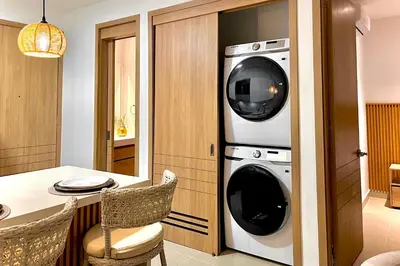 a kitchen with two washing machines and a table at 1 Recamara, Laguna, Paddleboard, Gym y Jacuzzi in Cartagena de Indias