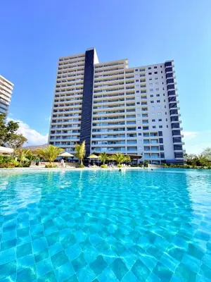 a large swimming pool in front of a large building at Modern Balcony Apartment with Sea View! in Santa Marta