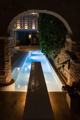 a swimming pool in a building with an arch at NOK Luxury Colonial Villa 6BR with Pool Staff & Breakfast at Getsemani in Cartagena de Indias