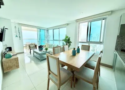 a dining room with a table and chairs at 3br Apartment in front of the beach 8 paxs in Cartagena de Indias