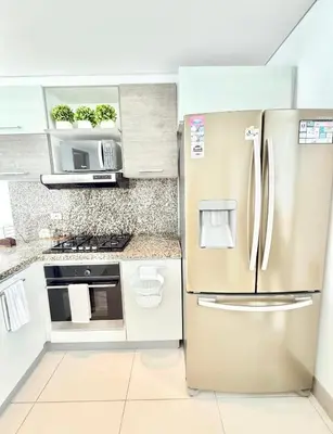 a kitchen with a stainless steel refrigerator at 3br Apartment in front of the beach 8 paxs in Cartagena de Indias