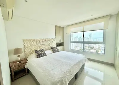 a white bedroom with a large bed and a window at 3br Apartment in front of the beach 8 paxs in Cartagena de Indias