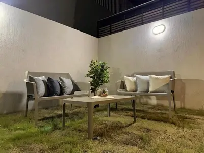two chairs and a table with pillows on them at refugio moderno in Barranquilla