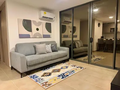 a living room with a couch and a rug at refugio moderno in Barranquilla