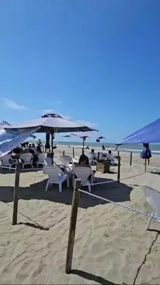 a beach with chairs and umbrellas on the sand at Apartamento completo, serena del mar, Capriella in Cartagena de Indias