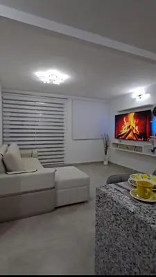 a living room with a white couch and a fireplace at Apartamento completo, serena del mar, Capriella in Cartagena de Indias