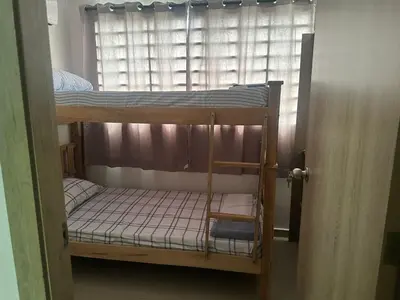 a bunk bed in a room with a window at Apartment in Barranquilla in Barranquilla