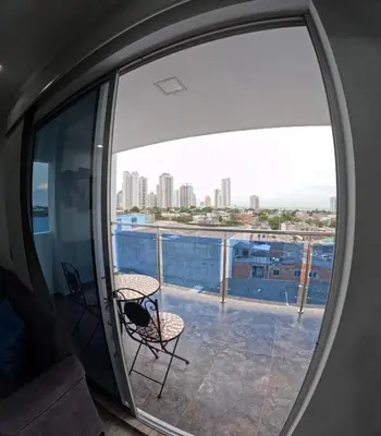 a view from a round window of a balcony with chairs at Apartamento Mirador cerca al Centro Historico in Cartagena de Indias