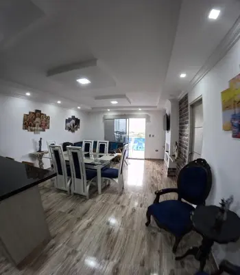 a dining room and living room with a table and chairs at Apartamento Mirador cerca al Centro Historico in Cartagena de Indias