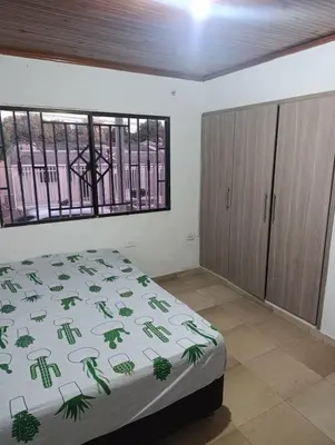 a bedroom with a bed and a window at Salomón el rey in Barranquilla