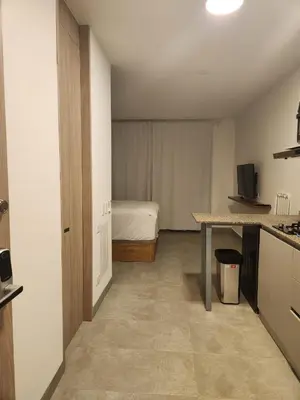 a room with a bedroom with a bed and a table at Apartamento vacacional con acceso al mar in Santa Marta