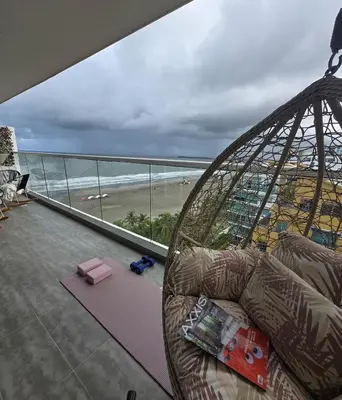 a living room with a couch and a view of a beach at Luxury Oceanfront Apartment Spiaggia 2BR 3BA Playa azul Cartagena in Cartagena de Indias