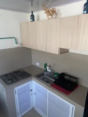 a small kitchen with a sink and a stove at Apartaestudio Equipado a Menos de 100m de la Playa in Cartagena de Indias