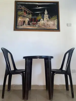 a black table with two chairs and a picture on the wall at Apartaestudio Equipado a Menos de 100m de la Playa in Cartagena de Indias
