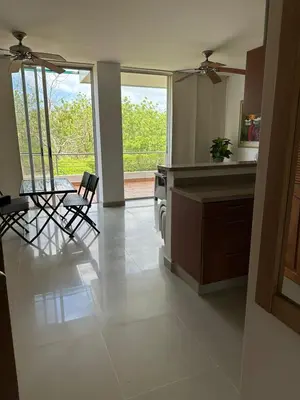 a kitchen with two chairs and a table and a window at CONDOMINIO LAGUNA CLUB 