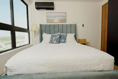 a bedroom with a white bed with a blue headboard at Now booking April! Walking to City Center 2 BDRM in Cartagena de Indias