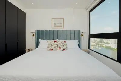 a bedroom with a large white bed and a window at Now booking April! Walking to City Center 2 BDRM in Cartagena de Indias