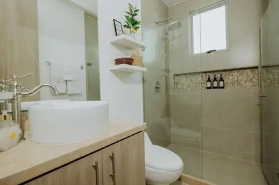a bathroom with a toilet and a shower and a sink at BEACH FRONT Condo walking to centro and beach 2BD in Cartagena de Indias