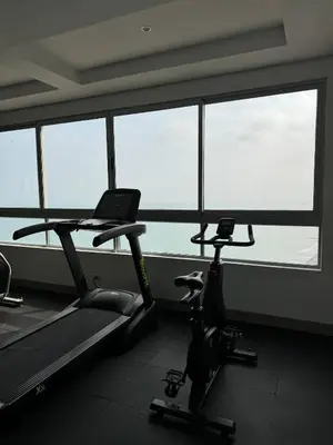 a gym with two exercise bikes in front of a window at BEACH FRONT Condo walking to centro and beach 2BD in Cartagena de Indias