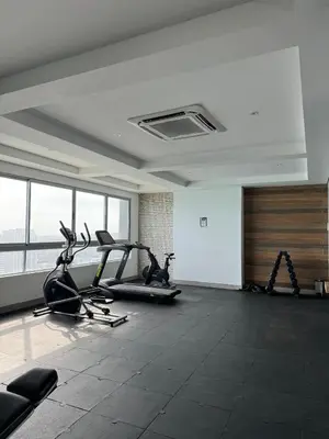 a gym with cardio equipment in a large room with windows at BEACH FRONT Condo walking to centro and beach 2BD in Cartagena de Indias