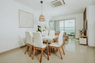 a dining room with a table and white chairs at BEACH FRONT Condo walking to centro and beach 2BD in Cartagena de Indias