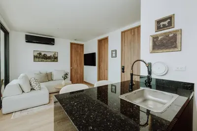 a kitchen with a sink and a living room at Cartagena View perfect for couples beach & walk in Cartagena de Indias