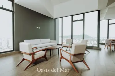 a living room with chairs and a couch and windows at Cartagena View perfect for couples beach & walk in Cartagena de Indias