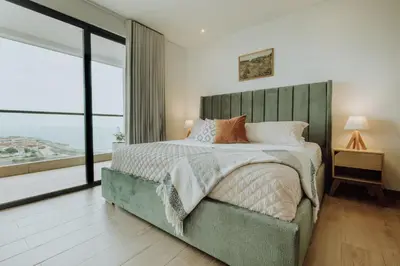 a bedroom with a large bed and a large window at Cartagena View perfect for couples beach & walk in Cartagena de Indias