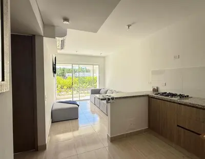 a kitchen with a counter and a couch in a room at Serena del Mar in Cartagena de Indias