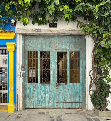 an old blue door on the side of a building at Cozy apartment Old City in Cartagena de Indias