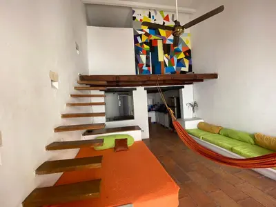 a living room with a hammock and a fireplace at Cozy apartment Old City in Cartagena de Indias