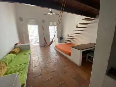 a bedroom with a hammock in the middle of a room at Cozy apartment Old City in Cartagena de Indias