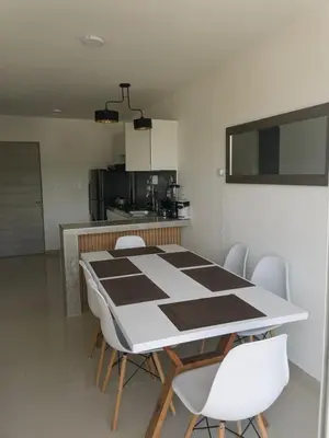 a dining room table and chairs in a kitchen at Modern & Cozy Apartment Near the Beach in Cartagena de Indias