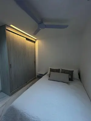 a bedroom with a large white bed and a door at Apt 2605 in Cartagena de Indias