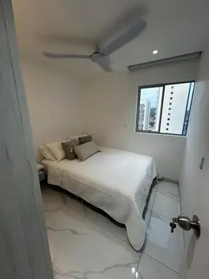 a bedroom with a bed and a ceiling fan at Apt 2605 in Cartagena de Indias