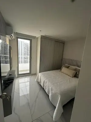 a bedroom with a bed and a large window at Apt 2605 in Cartagena de Indias