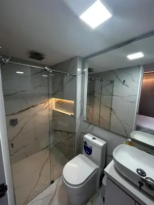 a bathroom with a toilet and a glass shower at Apt 2605 in Cartagena de Indias