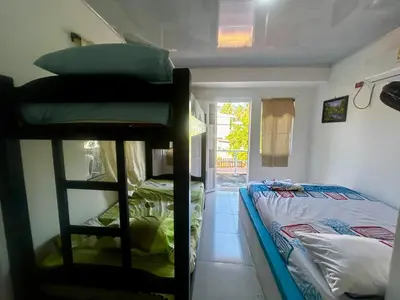 a room with two bunk beds and a bed at Costa Azul Isla Fuerte in Isla Fuerte