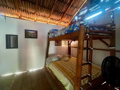 a bedroom with two bunk beds in a room at Costa Azul Isla Fuerte in Isla Fuerte