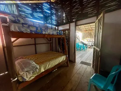 a bedroom with a bunk bed and a patio at Costa Azul Isla Fuerte in Isla Fuerte