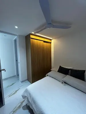 a bedroom with a large bed and a wooden door at Apt 2704 in Cartagena de Indias