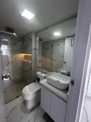 a white bathroom with a toilet and a sink at Apt 2704 in Cartagena de Indias