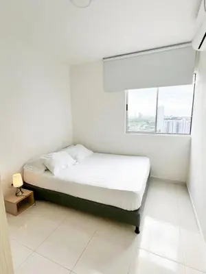 a white bedroom with a bed and a window at Apartamento 3 Habitaciones con Piscina cerca de las Playas de Cartagena in Cartagena de Indias