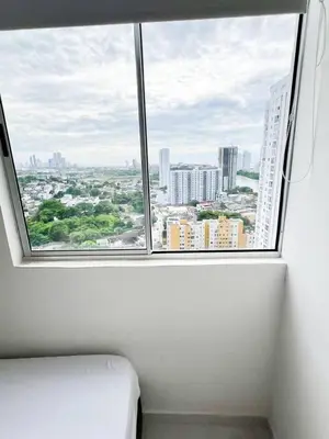 a window in a room with a view of a city at Apartamento 3 Habitaciones con Piscina cerca de las Playas de Cartagena in Cartagena de Indias