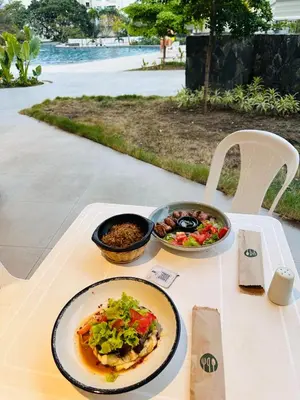 a table with a plate of food and a bowl of salad at Nuevo Loft santa Marta vista al mar piso 18 in Santa Marta