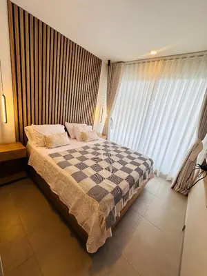 a bedroom with a checkered bed in front of a window at Nuevo Loft santa Marta vista al mar piso 18 in Santa Marta