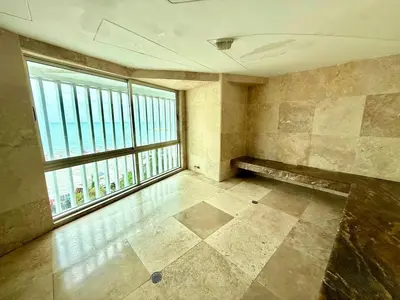 an empty room with a large window and a bench at 2Br apartment in front of the beach in Cartagena de Indias