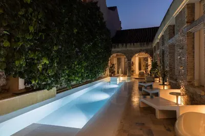 a swimming pool in a building with lights on at NOK Award Winning 4BR Villa wih pool at Getsemani in Cartagena de Indias