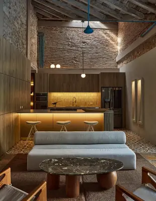 a large kitchen with a table and a counter at NOK Award Winning 4BR Villa wih pool at Getsemani in Cartagena de Indias
