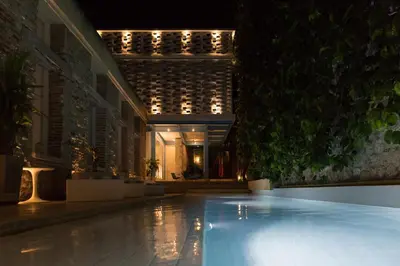 a swimming pool in a building at night at NOK Award Winning 4BR Villa wih pool at Getsemani in Cartagena de Indias